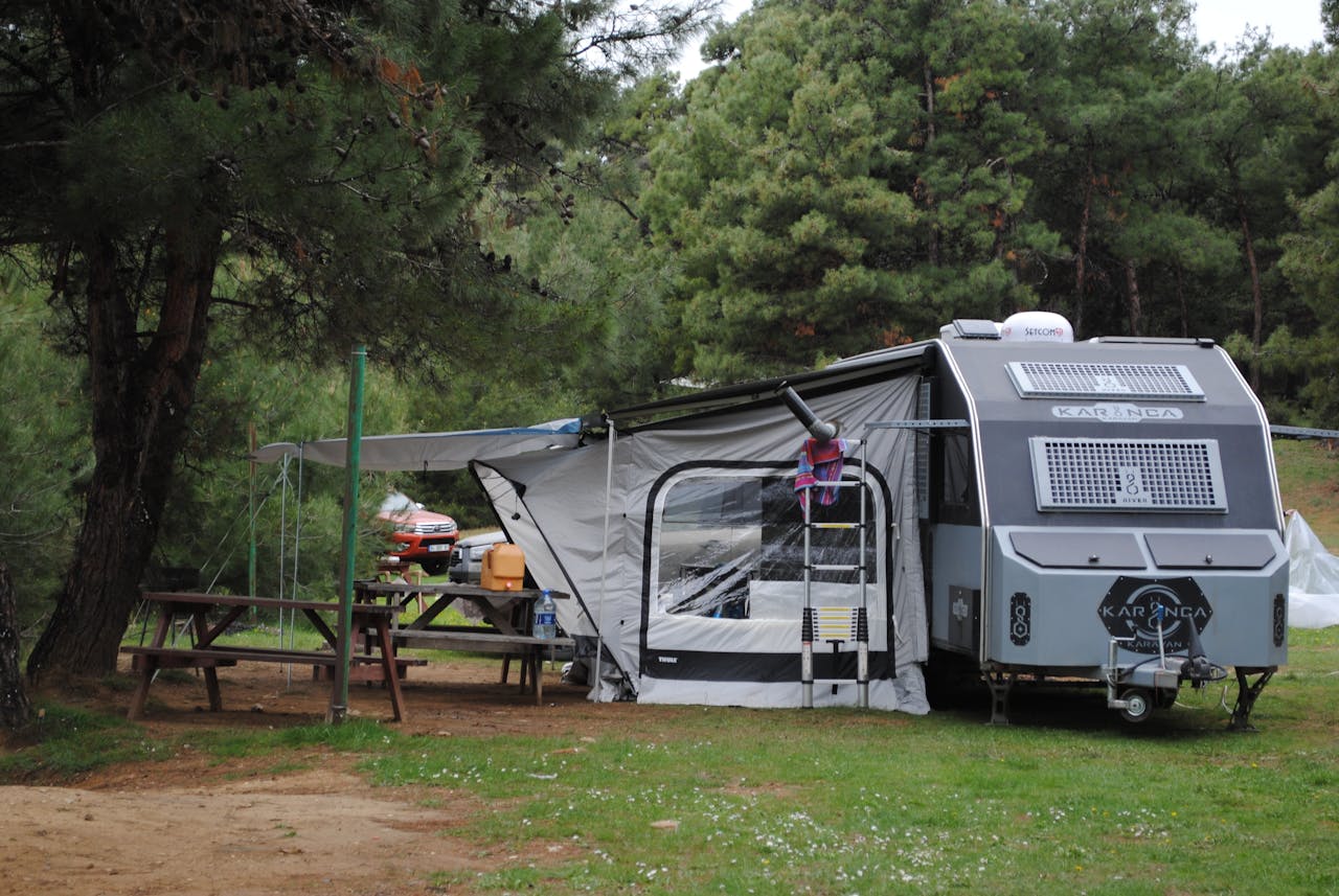 cozy-campsite-with-caravan-in-forest-setting-31995029